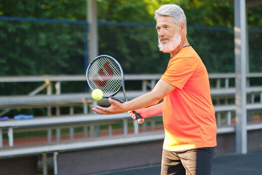 An active senior playing tennis